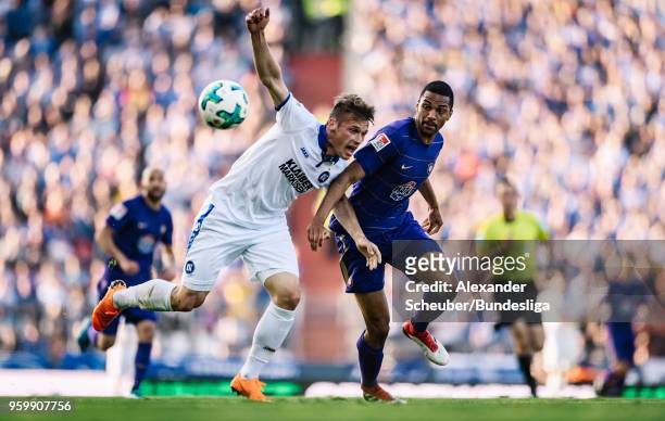 Marvin Pourie of Karlsruhe in action against Malcolm Cacutalua of Aue during the 2. Bundesliga Playoff Leg 1 match between Karlsruher SC and FC...