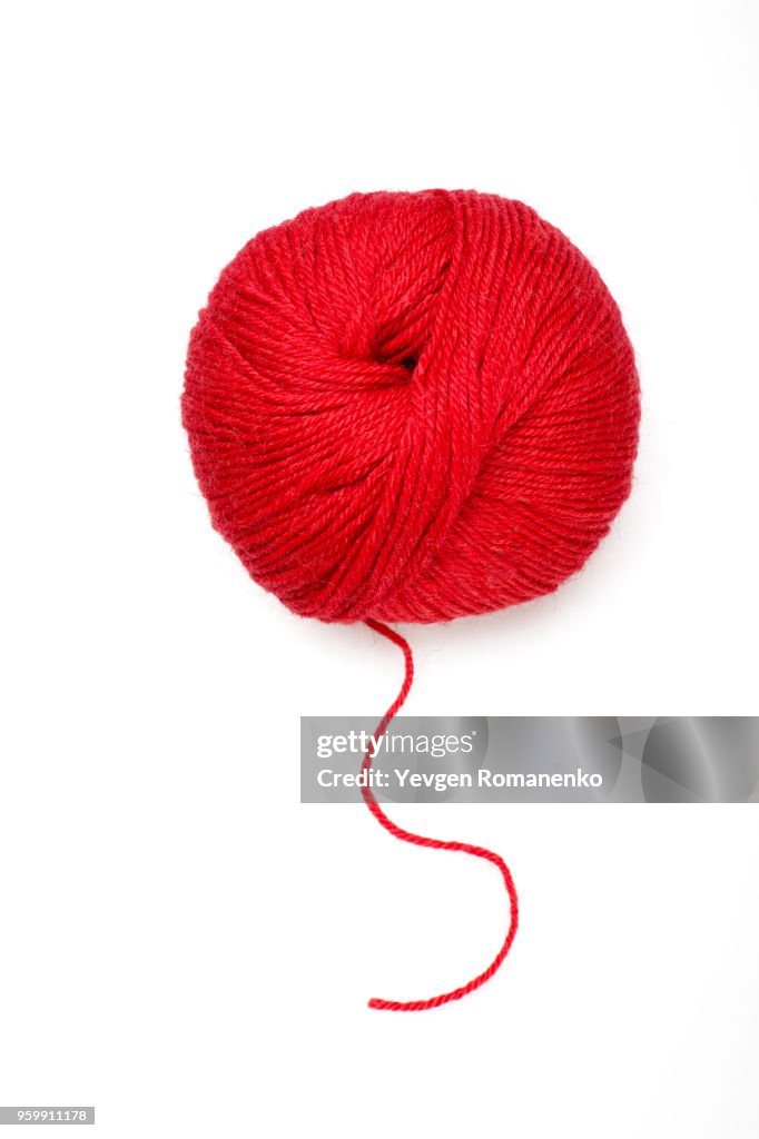 Red ball of wool on white background