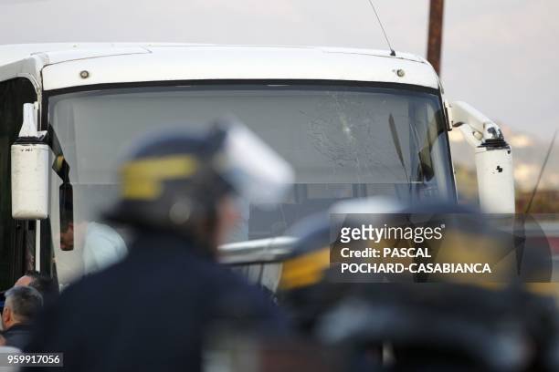 Anti-riot policemen stand close to the teambus of the Le Havre players after it was hit by a stone ahead of the French second round playoff football...