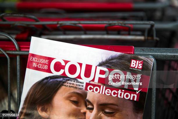 An advertisement for BJ's Wholesale Club Holdings Inc. 'Exclusive In-Club Coupon Collection' outside a location in Miami, Florida, U.S., on Friday,...