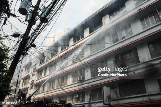 Firefighter puts out the fire that broke out at Wellington Building using a water cannon in Binondo, Manila, Philippines, on 18 May 2018. A fire of...