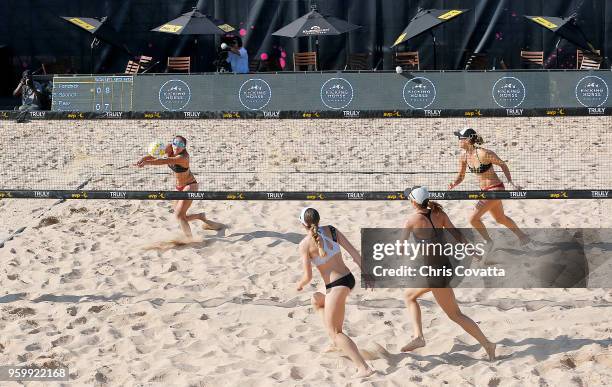 Sarah Sponcil bumps the ball against Angela Bensend and Olaya Pazo as teammate Lauren Fendrick watches during 2018 AVP Austin Open at Krieg Fields on...