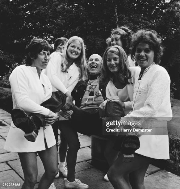 English former tennis player and fashion designer Ted Tinling is held up in the air by a group of female tennis players during his 62nd birthday...