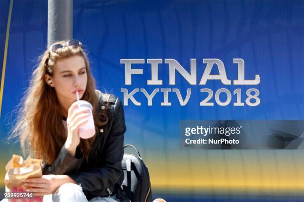 An Ukrainian woman sits near the logo the UEFA Champions League final in central Kiev, Ukraine, 18 May, 2018. The football UEFA Champions League...