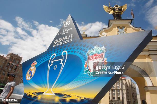 Man walks near a large sign showcasing the logo for the 2018 UEFA Champions League Final in central Kiev, Ukraine, 18 May, 2018. The football UEFA...