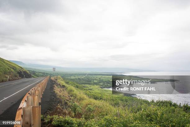 Vog from Kilauea's volcano explosions, the latest of which occured around 6:00 a.m. HST, descends over Highway 11 on the outskirts of Naalehu, HI on...