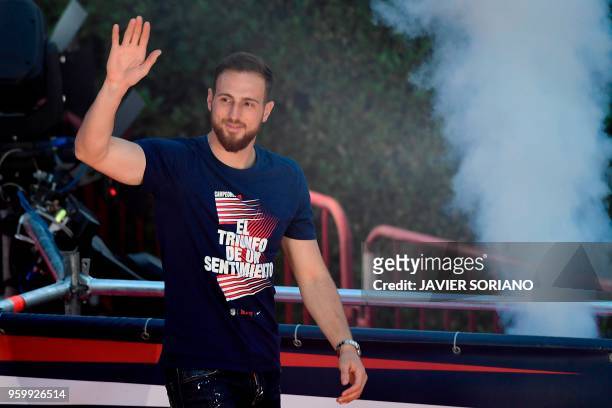 Atletico Madrid's Slovenian goalkeeper Jan Oblak waves at supporters during celebrations for their Europa League victory at the Fountain of Neptune...