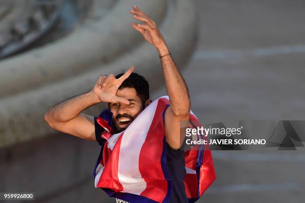 Atletico Madrid's Spanish forward Diego Costa gestures at supporters during celebrations for their Europa League victory at the Fountain of Neptune...