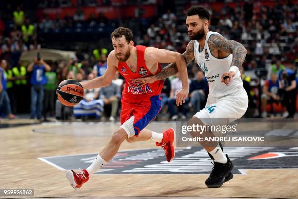 Moscow's Spanish guard Sergio Rodriguez controls the ball challenged by Real Madrid's Swedish forward Jeffery Taylor during the Euroleague Final Four...