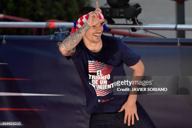 Atletico Madrid's French forward Antoine Griezmann gestures during celebrations for their Europa League victory at the Fountain of Neptune in Madrid...