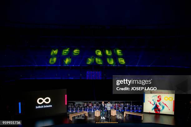 Barcelona's Spanish midfielder and captain Andres Iniesta listens to an introduction during a tribute at the Camp Nou stadium in Barcelona on May 18,...