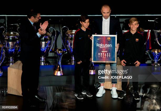 Barcelona's president Josep Maria Bartomeu applauds during a tribute to Barcelona's Spanish midfielder and captain Andres Iniesta at the Camp Nou...