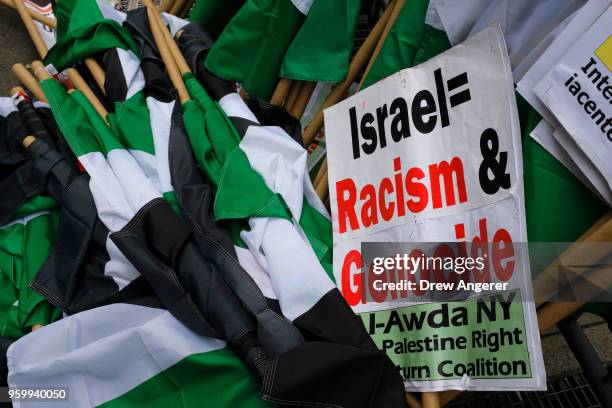Flags and signs lay on the ground during a rally in support of the Palestinian people in the wake of the recent violence in the Gaza Strip, during a...