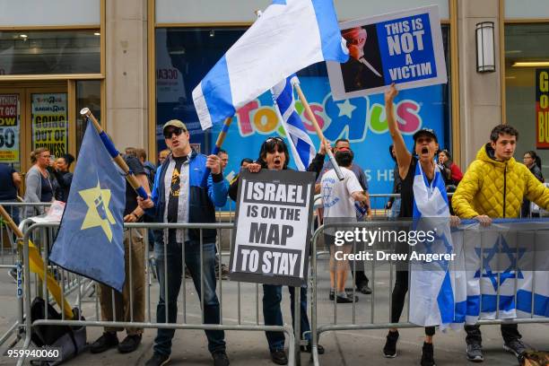 Counter-demonstrators protest across the street from a rally in support of the Palestinian people in the wake of the recent violence in the Gaza...