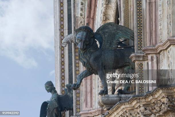 Lion of St Mark the Evangelist and Angel of St Matthew the Evangelist, by Lorenzo Maitani and Vitale Maitani , pillars at the entrance in the facade...