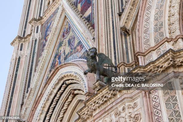 Lion of St Mark the Evangelist, by Lorenzo Maitani and Vitale Maitani , pillars at the entrance in the facade of Orvieto cathedral, Umbria, Italy,...