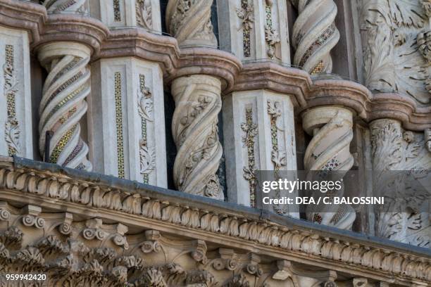 Twisted columns and piers with sculptural decoration and polychrome inlays, detail from the facade of Orvieto cathedral, Umbria, Italy, 13th-14th...