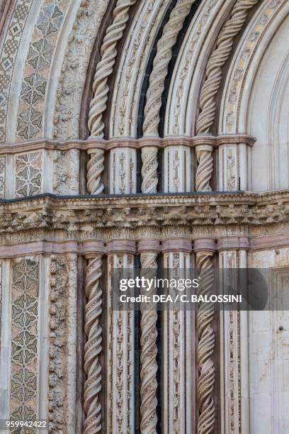 Twisted columns and piers with sculptural decoration and polychrome inlays, detail from the facade of Orvieto cathedral, Umbria, Italy, 13th-14th...