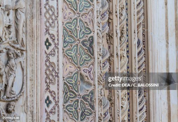 Twisted columns and piers with sculptural decoration and polychrome inlays, detail from the facade of Orvieto cathedral, Umbria, Italy, 13th-14th...