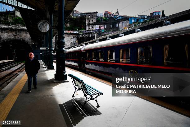 Man walks past the Presidential Train before its departure from the Sao Bento station in Porto on April 8, 2018. - Built in 1890, it once carried...