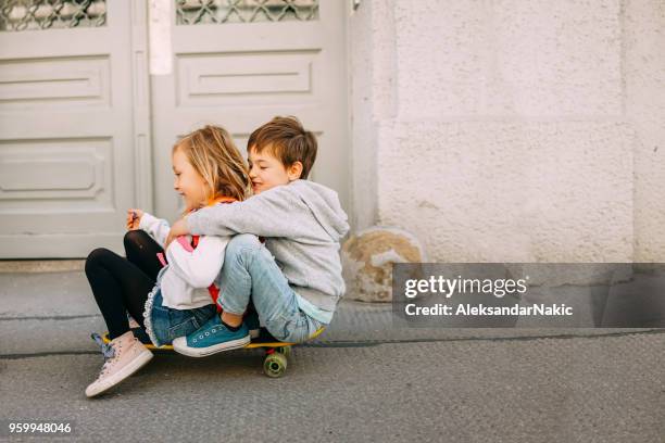 skateboarding down the city streets - sibling day stock pictures, royalty-free photos & images