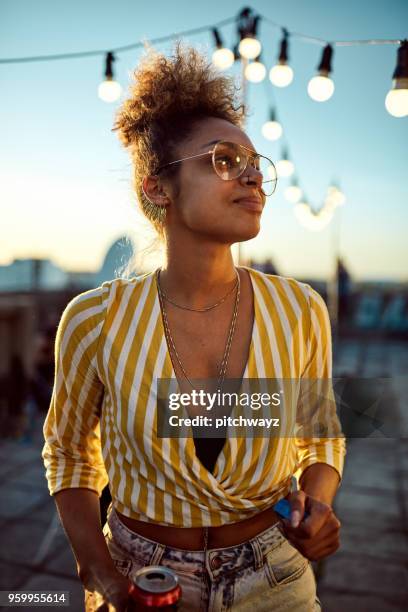 portrait of woman at roof party. - rooftop party stock pictures, royalty-free photos & images