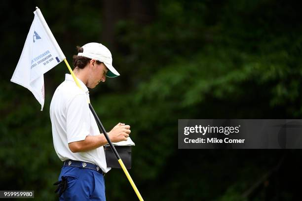 Brian Peccie of Washington & Lee looks on at the third putting green during the Division III Men's Golf Championship at the Grandover Resort on May...