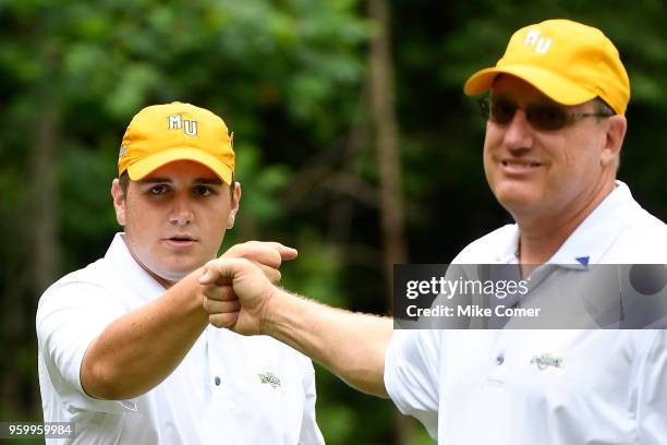 Dan Shepherd of Methodist University fist bumps his coach Steve Conley during the Division III Men's Golf Championship held at the Grandover Resort...