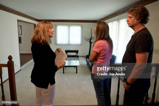 Michelle Workman, TRELORA showing agent greeting prospective buyers Debbie and Chris Humphrey of Denver. May 18, 2018 Greenwood Village, Colorado.