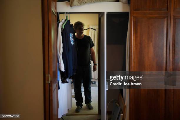 Prospective buyer Chris Humphrey of Denver looking into a walk through closet in the upstairs bedrooms during a showing in Greenwood Village. May 18,...