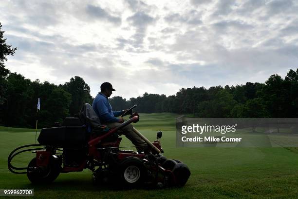Groundskeeper mows the sixth green prior to the start of competition at the Division III Men's Golf Championship held at the Grandover Resort on May...