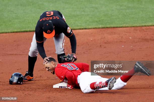 Mookie Betts of the Boston Red Sox slides into second past Jonathan Schoop of the Baltimore Orioles after hitting a double in the first inning at...