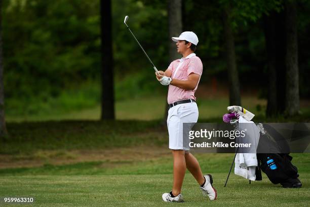 Logan Young of Concordia University plays a five iron from a fairway during the Division III Men's Golf Championship held at the Grandover Resort on...