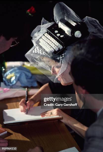 American singer, actress, and author Bette Midler a book during a signing at a B Dalton bookseller, New York, New York, May 1, 1980. Midler, who...