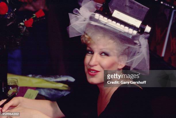 American singer, actress, and author Bette Midler smiles during a book signing at a B Dalton bookseller, New York, New York, May 1, 1980. Midler, who...