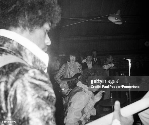 View of Jimi Hendrix performing live on stage with the Jimi Hendrix Experience at the Barbeque 67 music festival at the Tulip Bulb Auction Hall in...