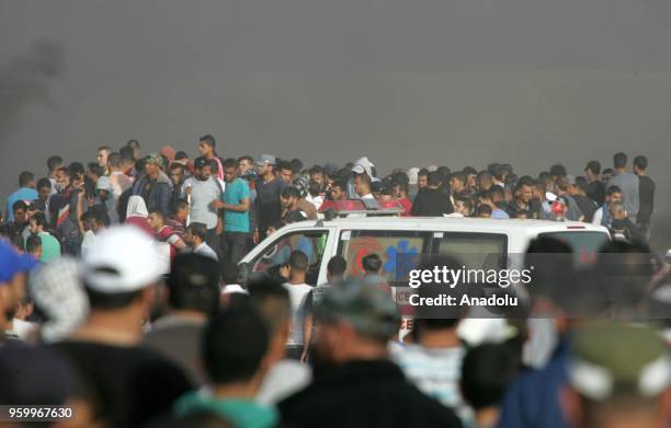 Smoke of burning tires rise over Palestinians during a demonstration, on the 8th week of the "Great March of Return", at Gaza-Israel border in...