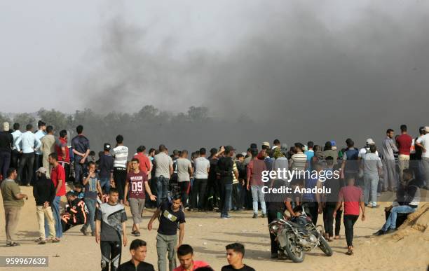 Smoke of burning tires rise over Palestinians during a demonstration, on the 8th week of the "Great March of Return", at Gaza-Israel border in...