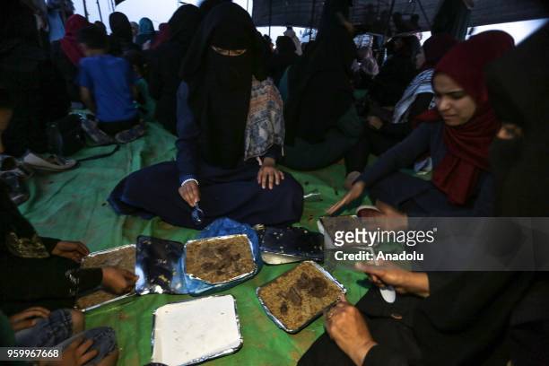 Palestinians break their fast at an iftar dinner within a demonstration, on the 8th week of the "Great March of Return", at Gaza-Israel border in...