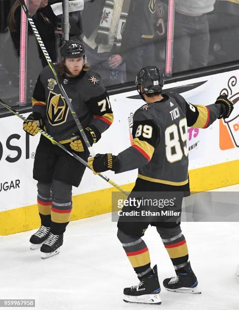 William Karlsson is congratulated by his teammate Alex Tuch of the Vegas Golden Knights after scoring a first-period goal against the Winnipeg Jets...