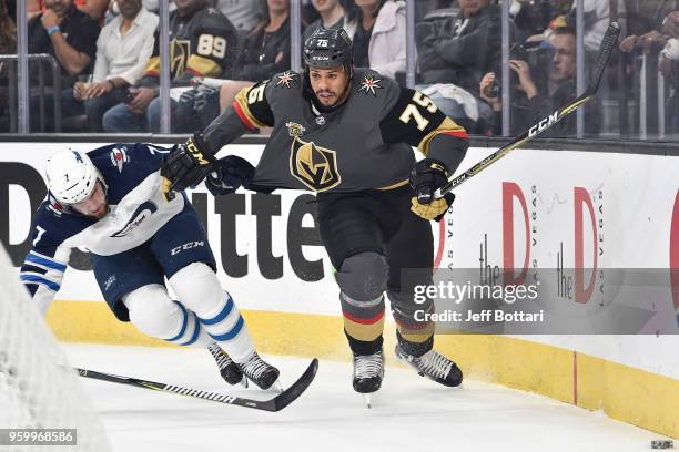 Ryan Reaves of the Vegas Golden Knights and Ben Chiarot of the Winnipeg Jets skate to the puck in Game Four of the Western Conference Final during...