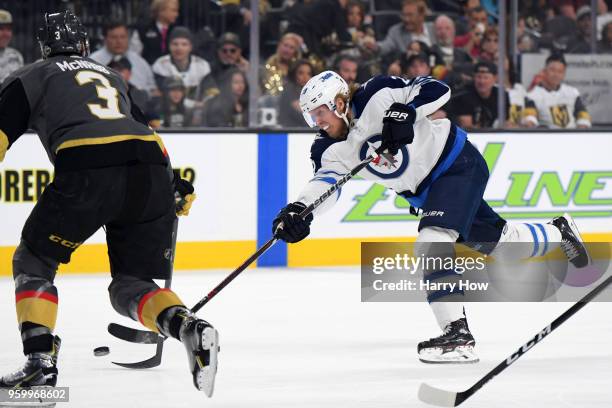 Patrik Laine of the Winnipeg Jets takes a shot as Brayden McNabb of the Vegas Golden Knights defends during the first period in Game Four of the...