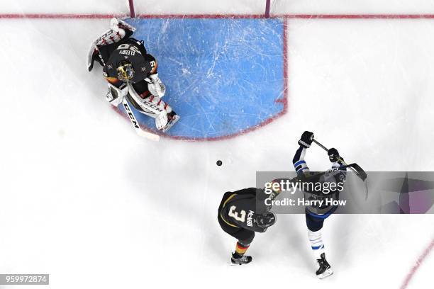 Marc-Andre Fleury makes a save as teammate Brayden McNabb of the Vegas Golden Knights defends against Mark Scheifele of the Winnipeg Jets during the...