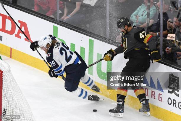 Patrik Laine of the Winnipeg Jets gets tripped up against Luca Sbisa of the Vegas Golden Knights during the first period in Game Four of the Western...