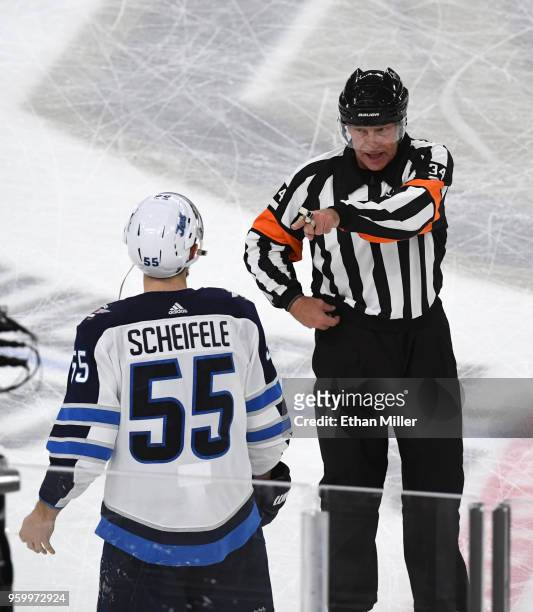 Mark Scheifele of the Winnipeg Jets argues his slashing penalty with referee Brad Meier against the Vegas Golden Knights during the first period in...