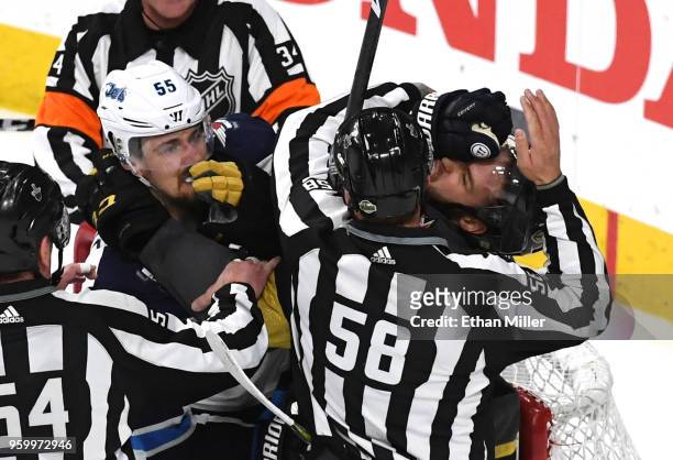 Mark Scheifele of the Winnipeg Jets and Brayden McNabb of the Vegas Golden Knights mix it up after the whistle during the first period in Game Four...