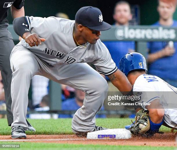 Kansas City Royals' Whit Merrifield steals third before the tag from New York Yankees third baseman Miguel Andujar in the first inning during...