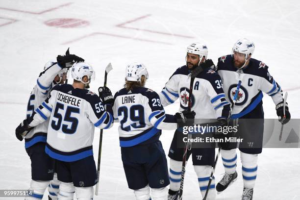 Patrik Laine of the Winnipeg Jets is congratulated by his teammates after scoring a second-period goal against the Vegas Golden Knights in Game Four...
