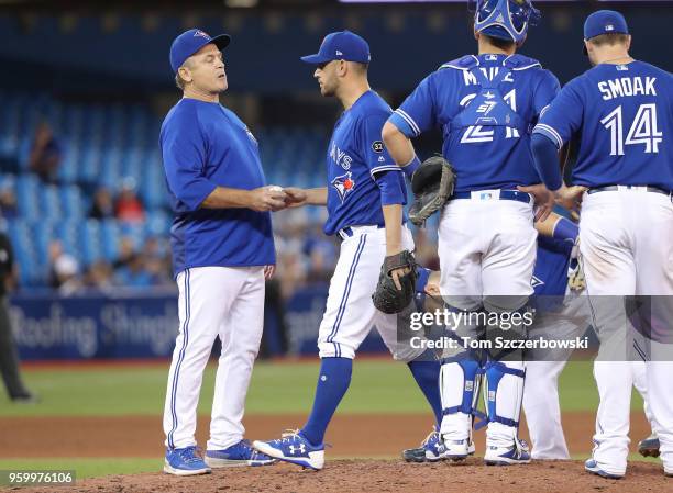 Marco Estrada of the Toronto Blue Jays exits the game as he is relieved by manager John Gibbons in the seventh inning during MLB game action against...