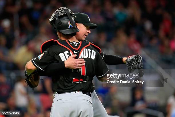 Pitcher Brad Ziegler of the Miami Marlins celebrates with J.T. Realmuto after beating the Atlanta Braves at SunTrust Park on May 18, 2018 in Atlanta,...